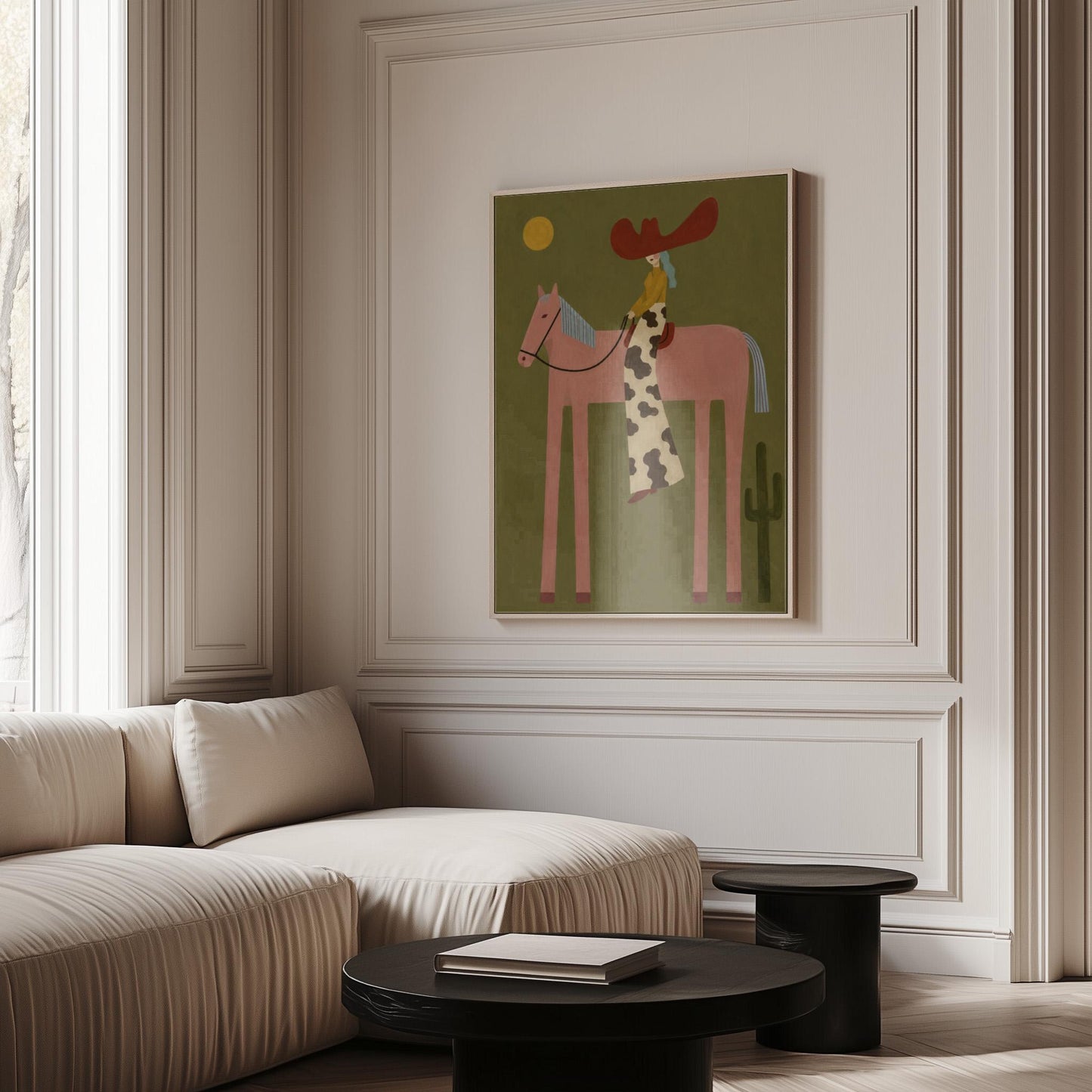 Cowgirl in a red hat riding a long-legged pink horse past a cactus at sunset, canvas print shown in a sunlit, contemporary room