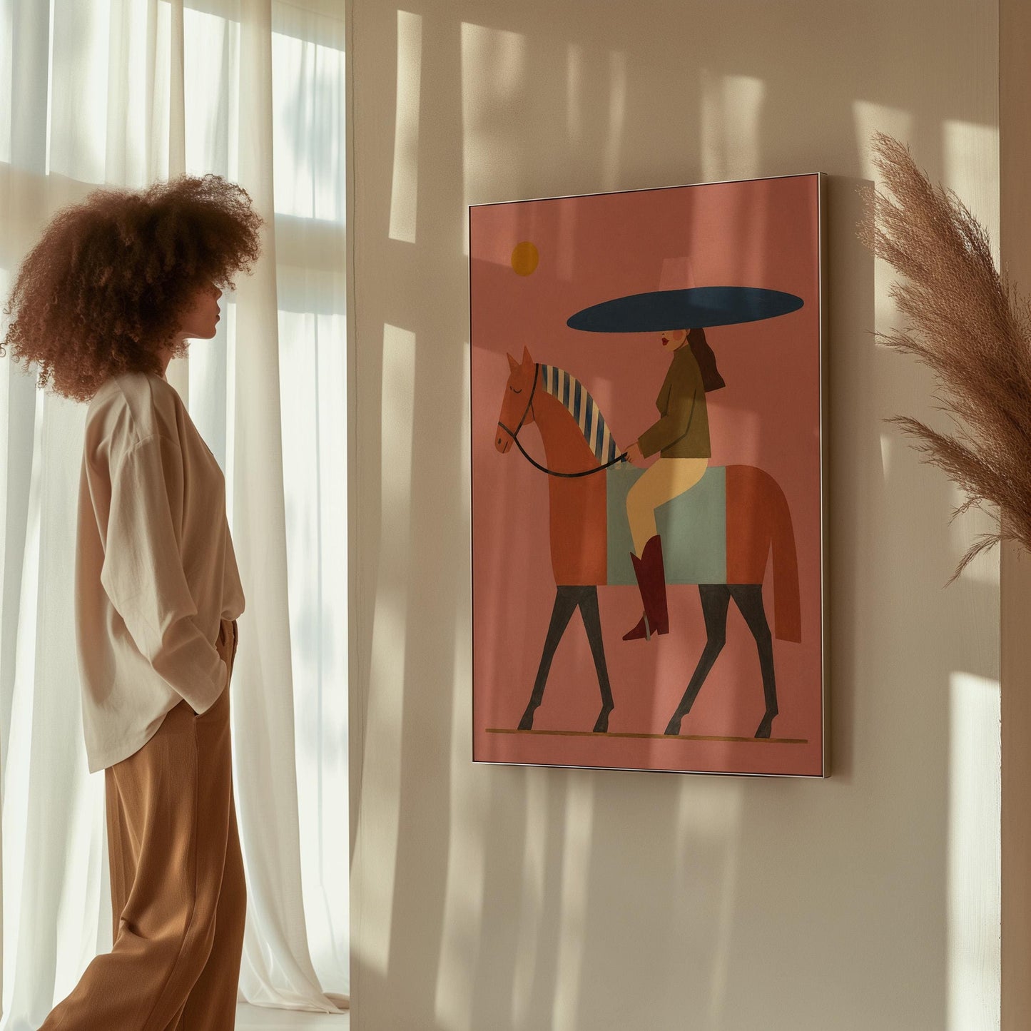 Woman in a wide navy hat riding a chestnut horse in profile on coral pink, canvas print displayed on a neutral wall in a styled interior
