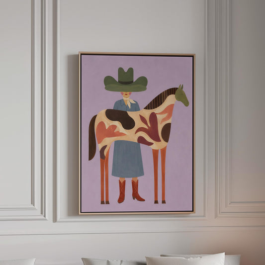 Cowgirl in a green hat beside a tall patterned horse on soft lilac, canvas print in a bright room with natural daylight