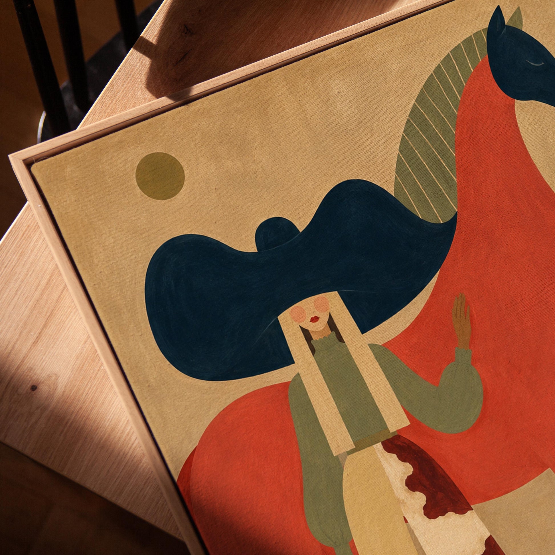 Woman in a big navy hat standing before a bright red horse on warm ochre, canvas print in a warm, minimally styled interior