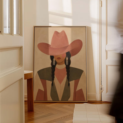 Cowgirl with dark braids under a wide terracotta hat and earthy western jacket, canvas wall art styled against a soft white wall