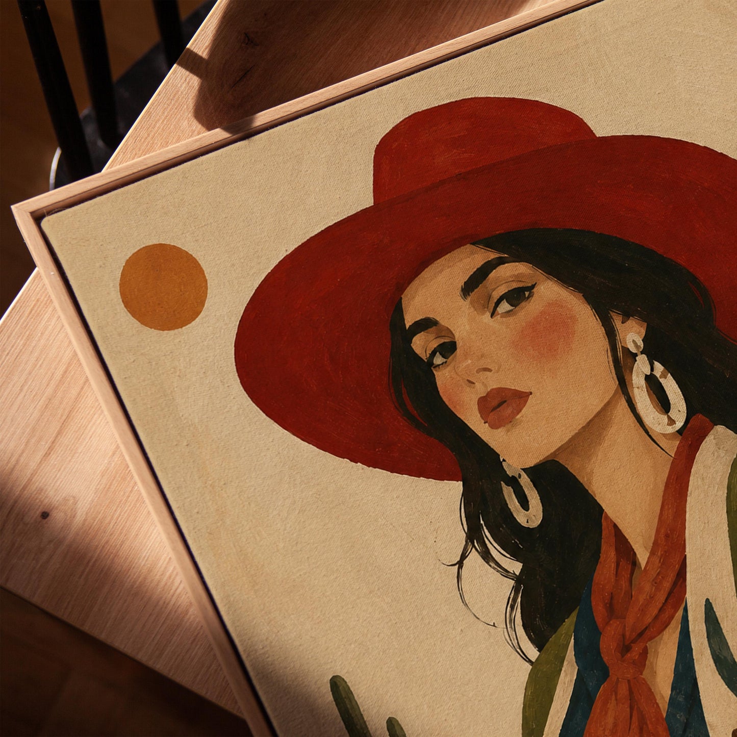 Dark-haired cowgirl in a red hat and cow-print jacket before a desert cactus, canvas print in a warm, minimally styled interior