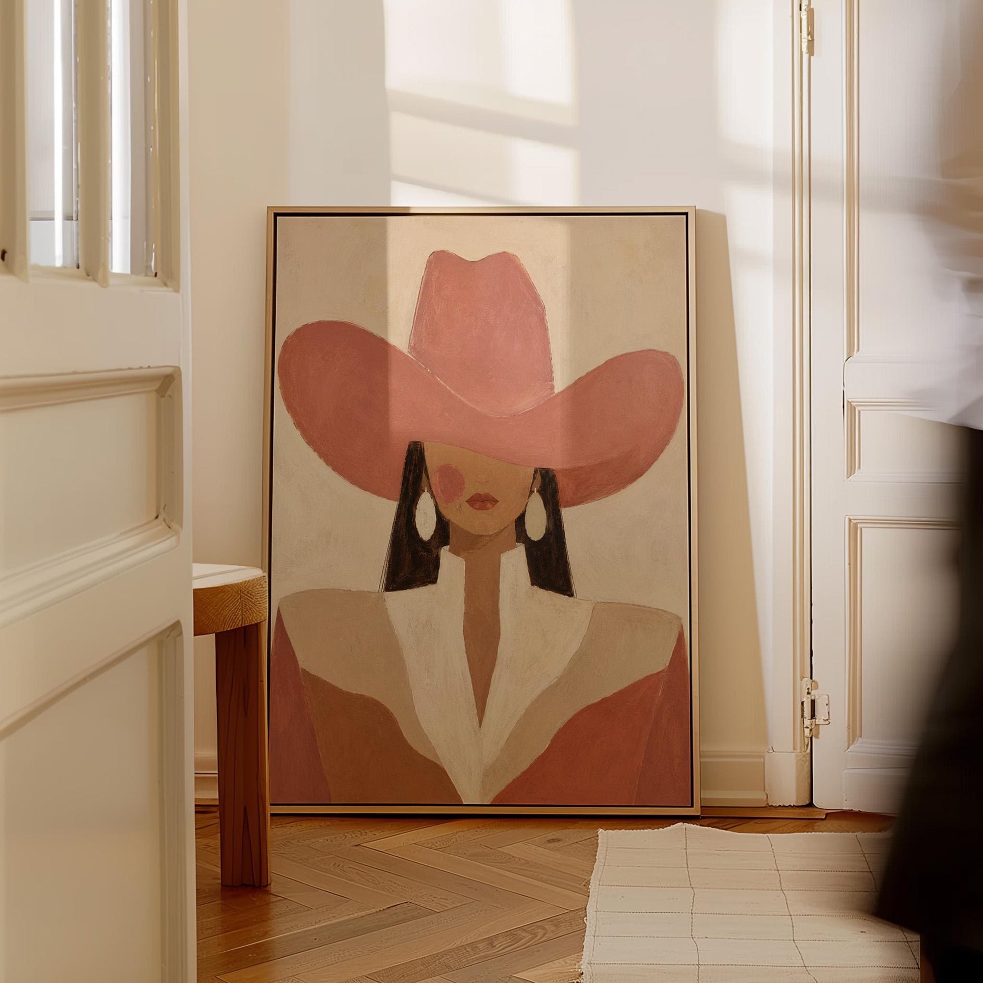 Minimal cowgirl in a coral hat and white collar with dark hair on cream, canvas wall art seen in a warm interior with natural light