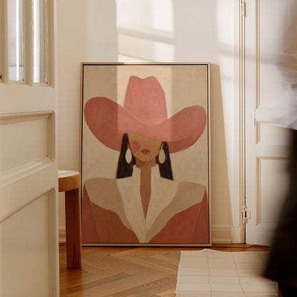 Minimal cowgirl in a coral hat and white collar with dark hair on cream, canvas wall art seen in a warm interior with natural light