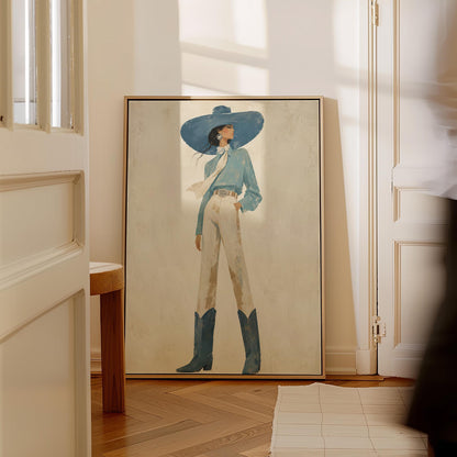 Full-figure cowgirl in a wide teal hat, blouse and boots with cream trousers, canvas print presented in a light, minimal room