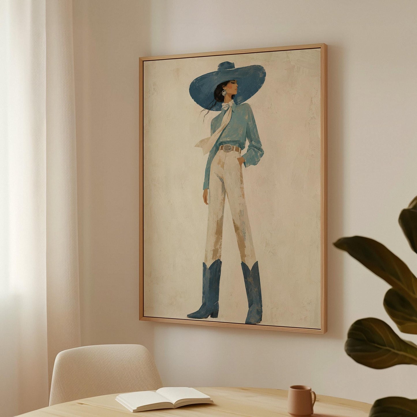 Full-figure cowgirl in a wide teal hat, blouse and boots with cream trousers, canvas wall art hanging in a calm, modern living space