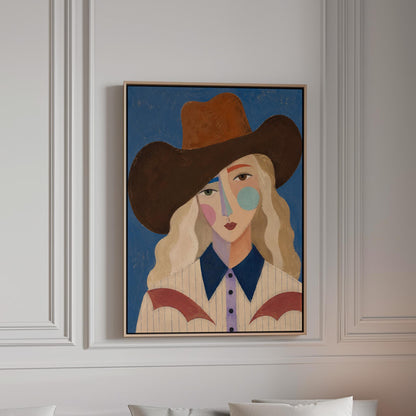 Blonde cowgirl in a rust hat with a cubist pastel face on deep blue, canvas print in a bright room with natural daylight