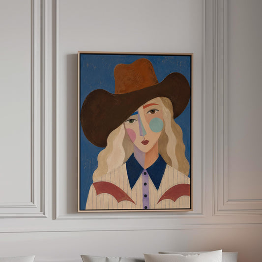 Blonde cowgirl in a rust hat with a cubist pastel face on deep blue, canvas print in a bright room with natural daylight