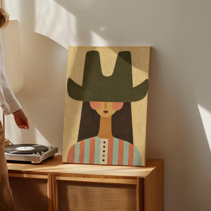 Folk cowgirl in a big green hat and striped shirt with long dark hair, canvas print seen in a warm interior with natural light
