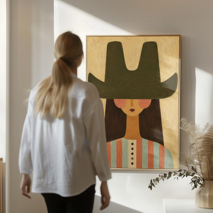Folk cowgirl in a big green hat and striped shirt with long dark hair, canvas print presented in a light, minimal room