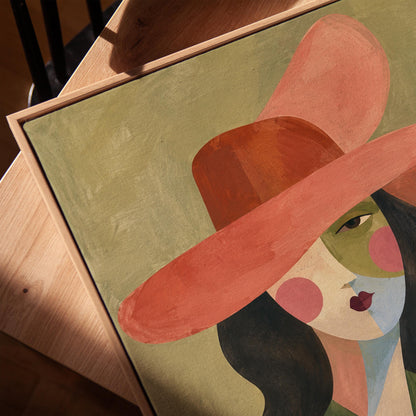 Abstract cowgirl in a wide coral hat with a cow print vest and dark hair, canvas print in a warm, minimally styled interior