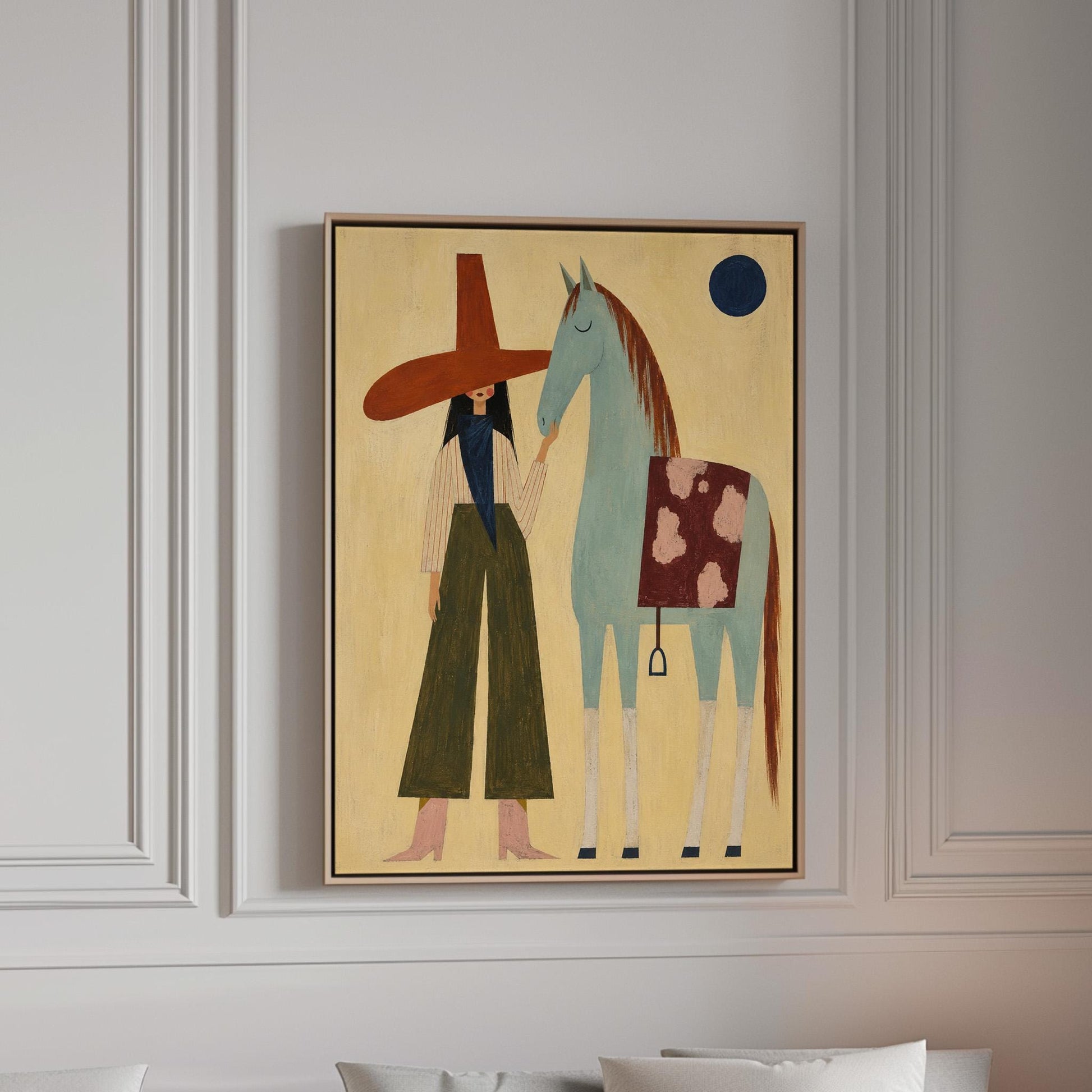 Woman in a wide red hat standing beside a gentle blue horse in the desert, canvas print in a bright room with natural daylight