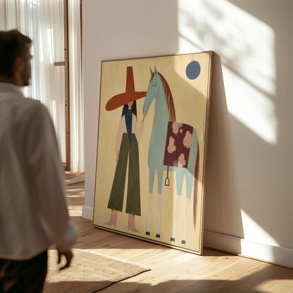 Woman in a wide red hat standing beside a gentle blue horse in the desert, canvas print shown in a sunlit, contemporary room
