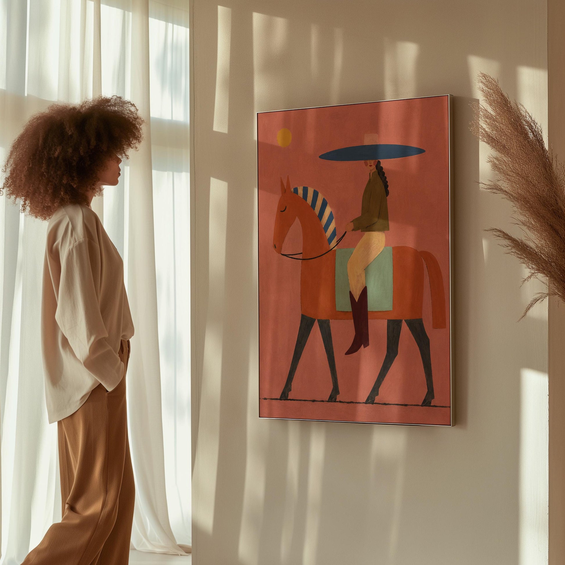 Cowgirl in a broad blue hat riding a rust red horse across a coral sky, canvas print hanging in a calm, modern living space