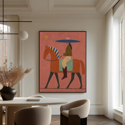 Cowgirl in a broad blue hat riding a rust red horse across a coral sky, canvas print displayed on a neutral wall in a styled interior