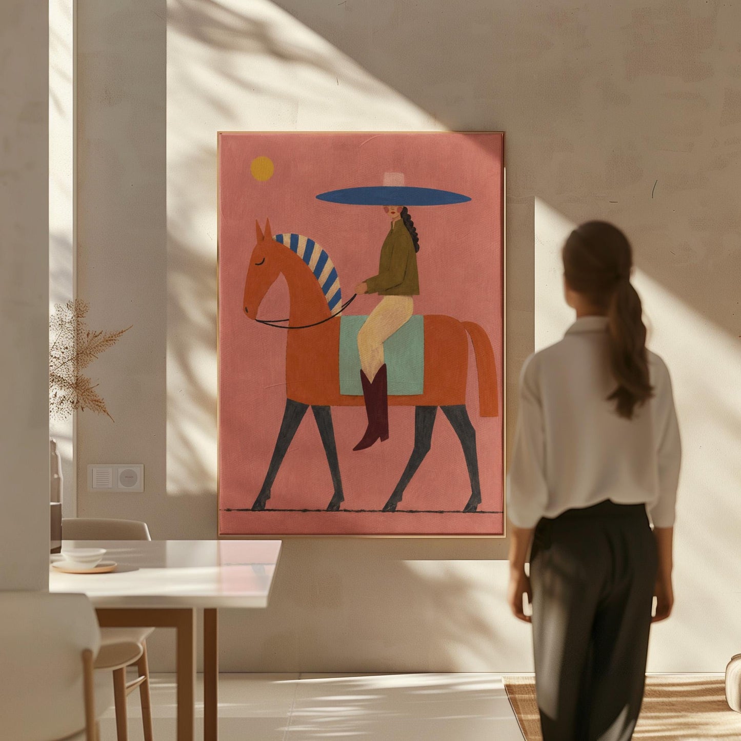Cowgirl in a broad blue hat riding a rust red horse across a coral sky, canvas wall art presented in a light, minimal room