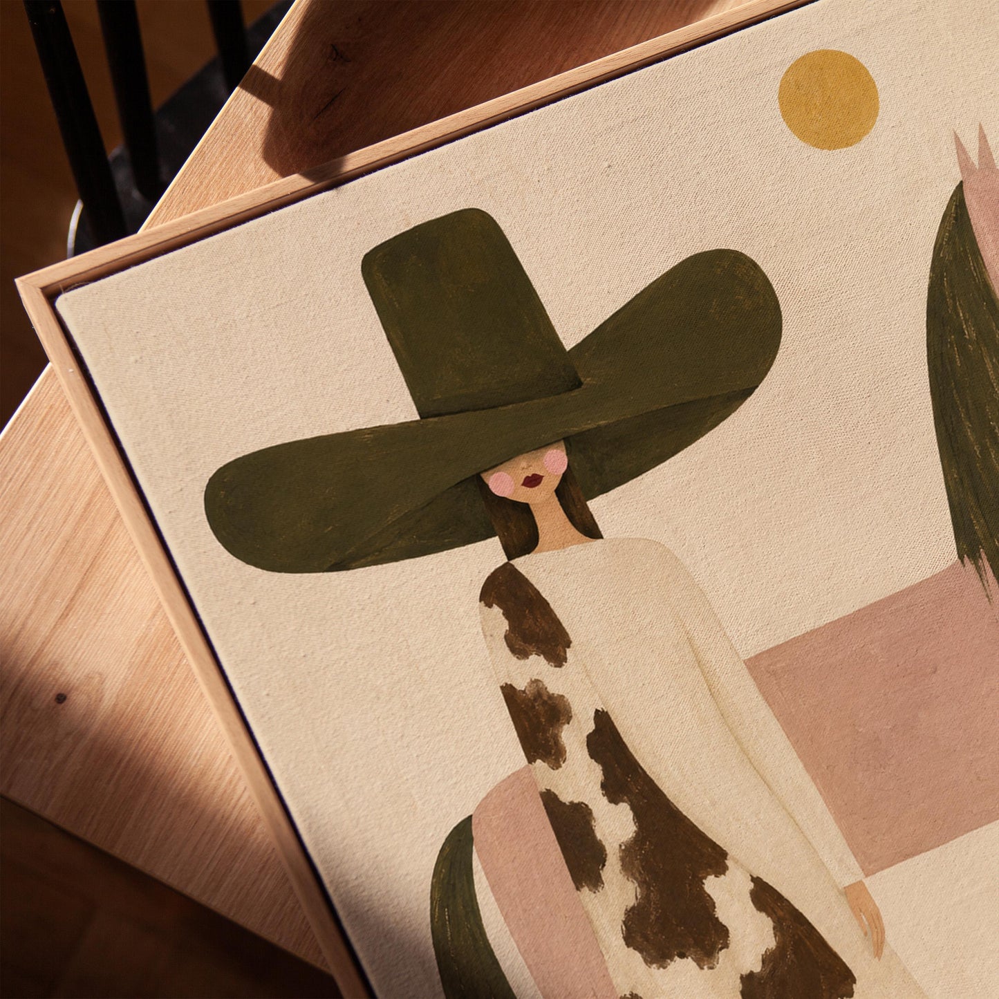 Woman in a tall dark hat standing beside a soft pink horse with olive mane, canvas print in a warm, minimally styled interior