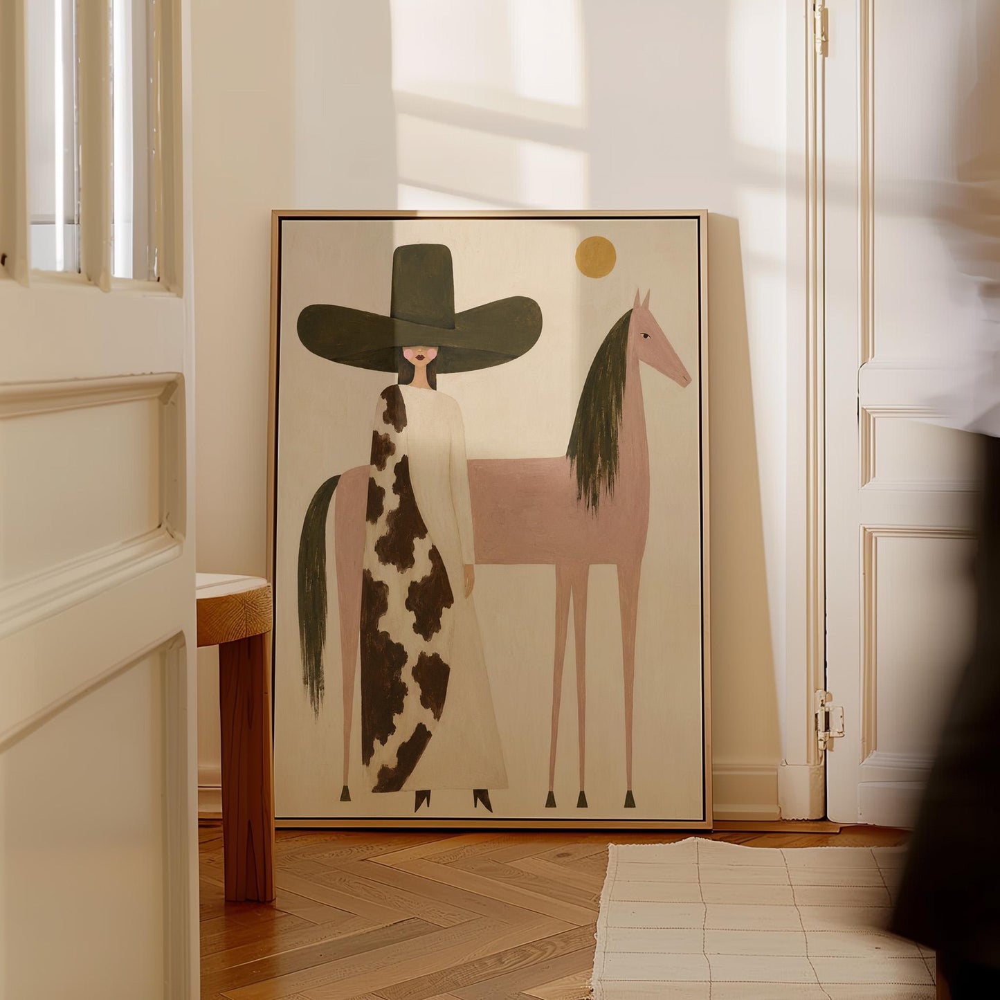 Woman in a tall dark hat standing beside a soft pink horse with olive mane, canvas print presented in a light, minimal room