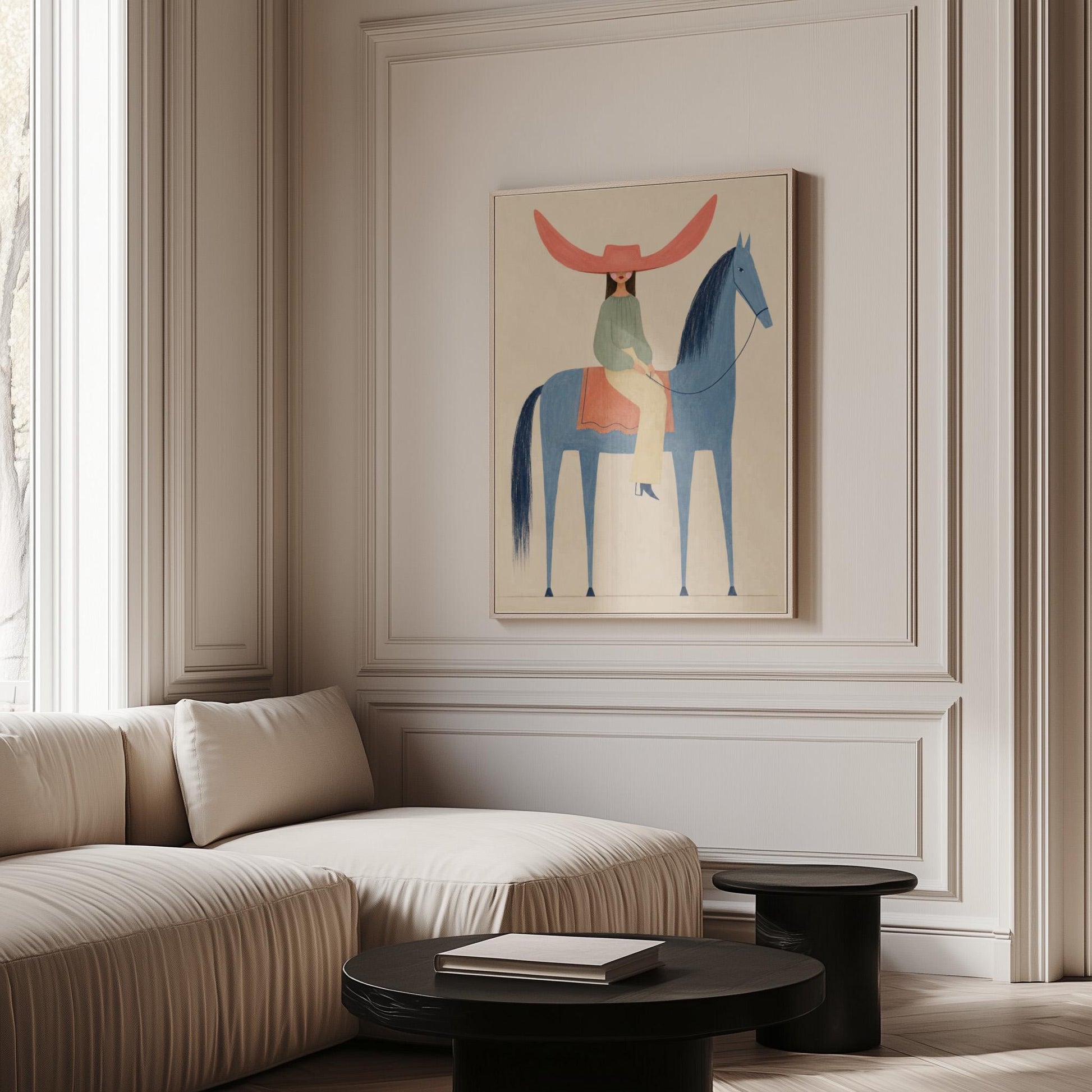 Cowgirl in a dramatic red hat riding a slender blue horse across pale sand, canvas wall art on a quiet wall in a considered interior