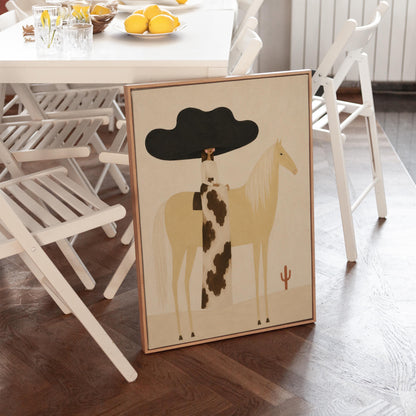Woman in a huge black hat riding a pale palomino across a desert with cactus, canvas print displayed on a neutral wall in a styled interior