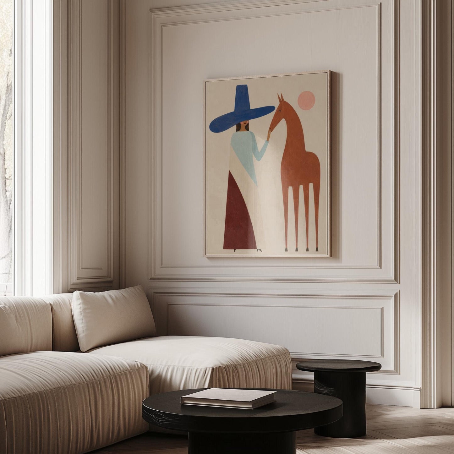 Woman in a tall blue hat reaching to a slim chestnut horse under a pink sun, canvas print displayed on a neutral wall in a styled interior