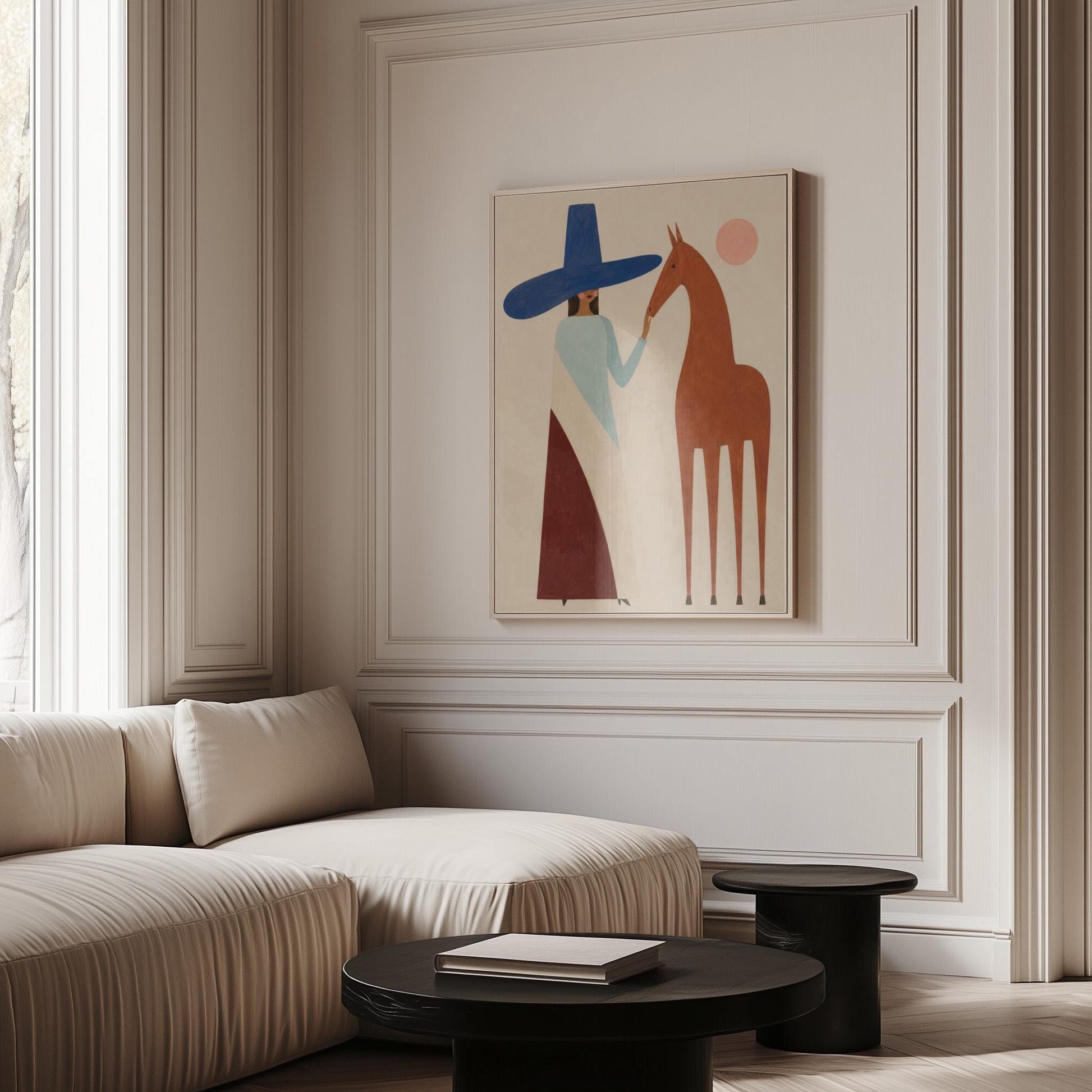 Woman in a tall blue hat reaching to a slim chestnut horse under a pink sun, canvas print displayed on a neutral wall in a styled interior