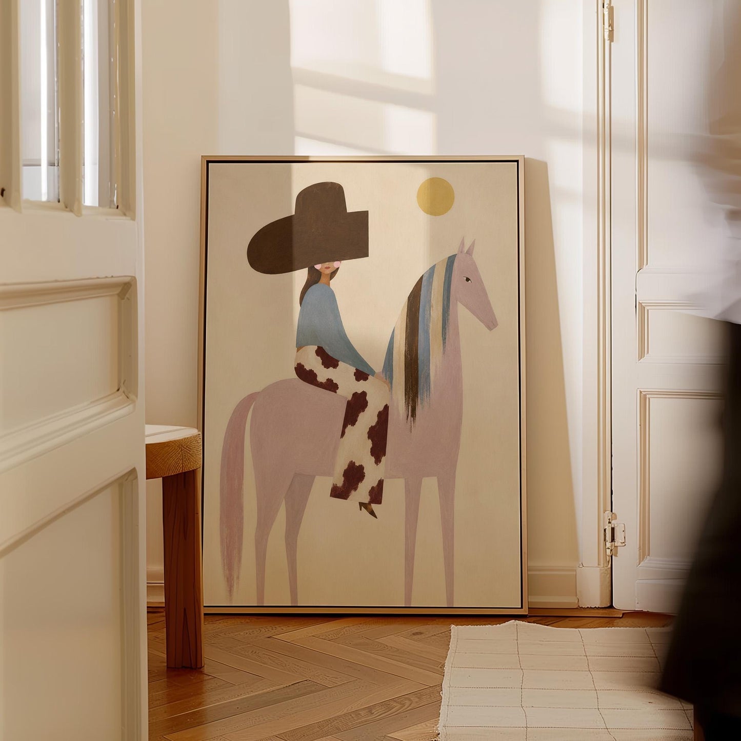 Woman in a large brown hat riding a soft pink horse with a striped mane, canvas print seen in a warm interior with natural light