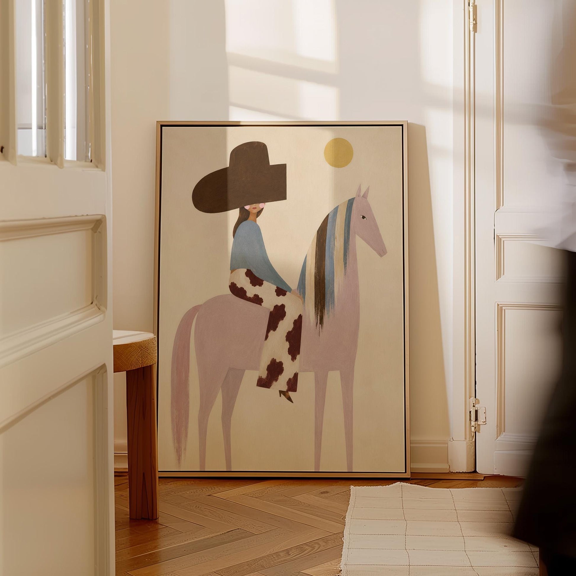 Woman in a large brown hat riding a soft pink horse with a striped mane, canvas print seen in a warm interior with natural light