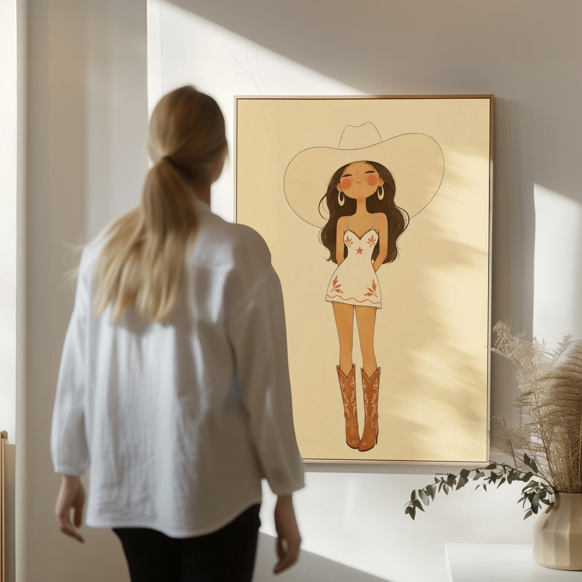 Cowgirl in a white dress, pale cowboy hat and tan boots on a cream ground, canvas print displayed on a neutral wall in a styled interior