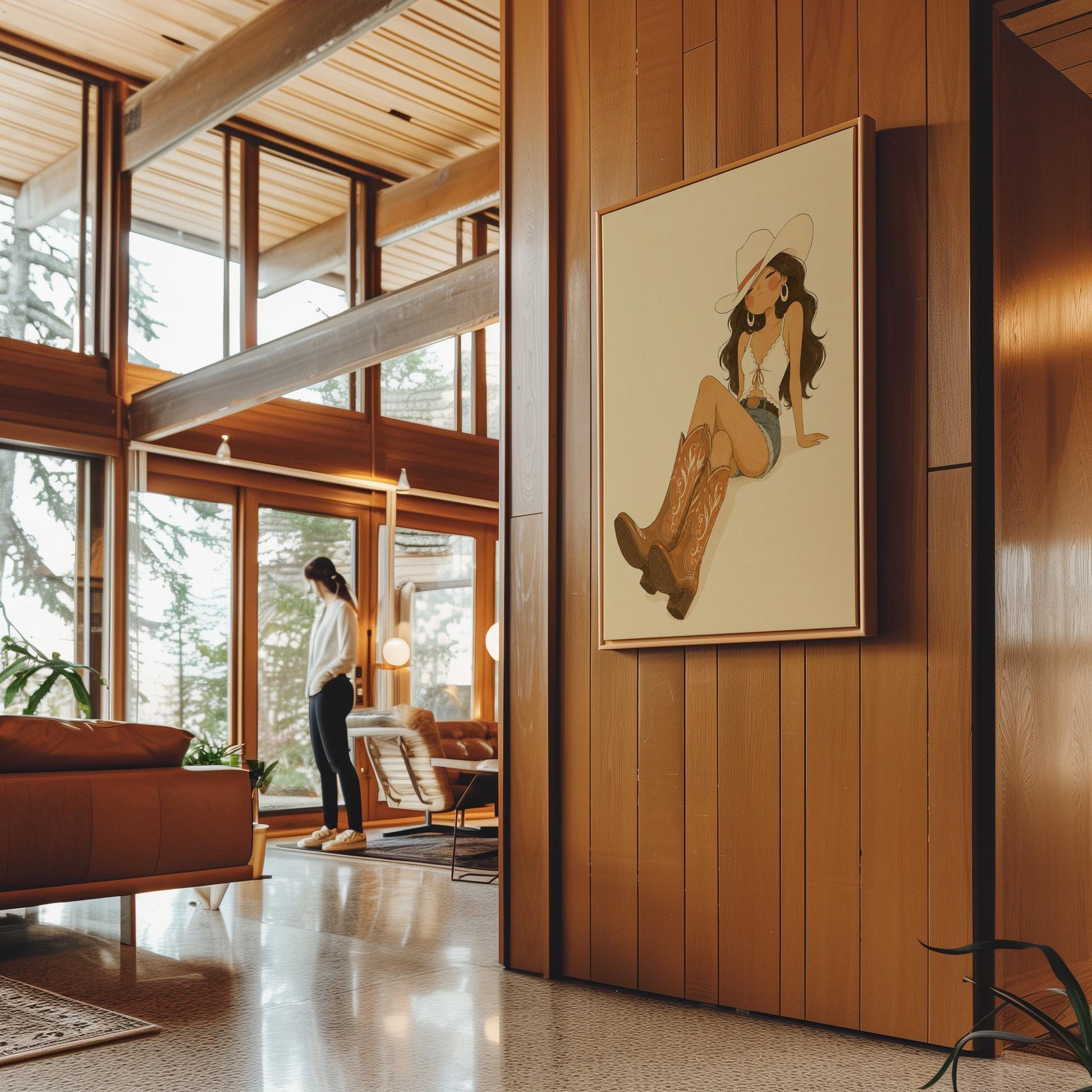 Cowgirl in denim shorts and cowboy boots leaning back under a wide pale hat, canvas print seen in a warm interior with natural light