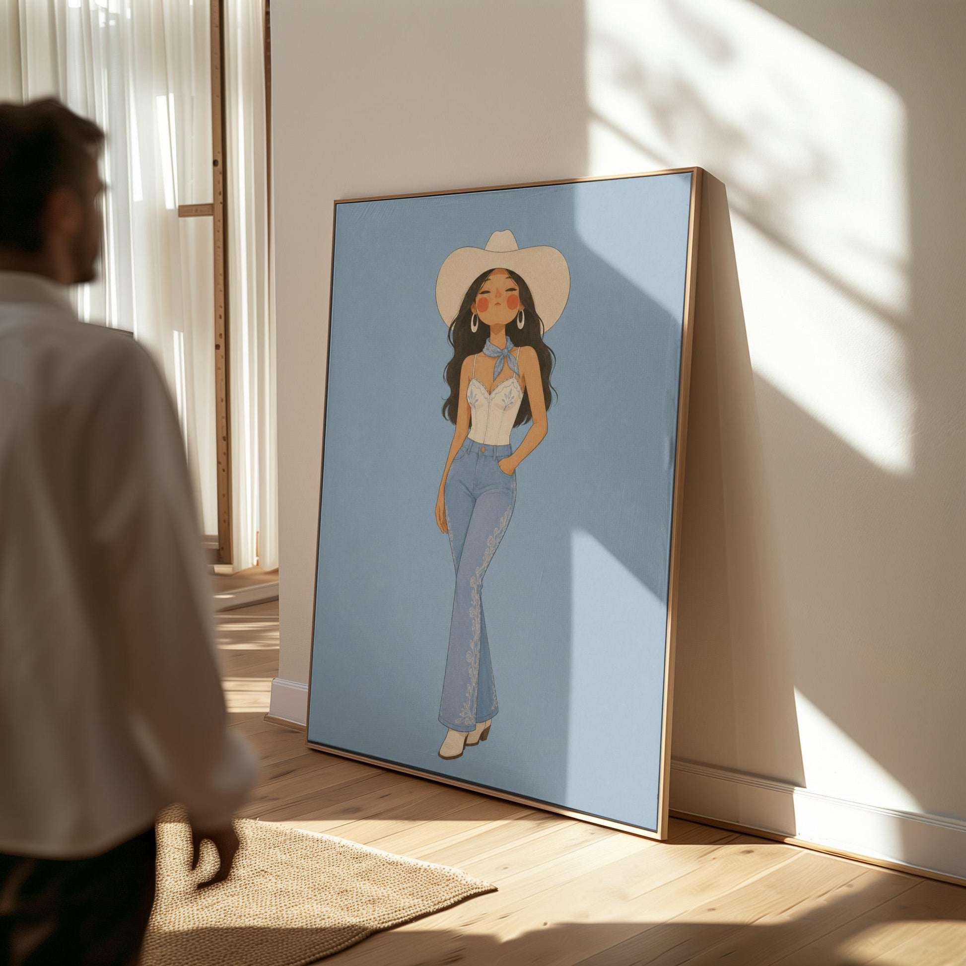 Cowgirl in flare jeans and white top against a dusty blue field, canvas print presented in a light, minimal room
