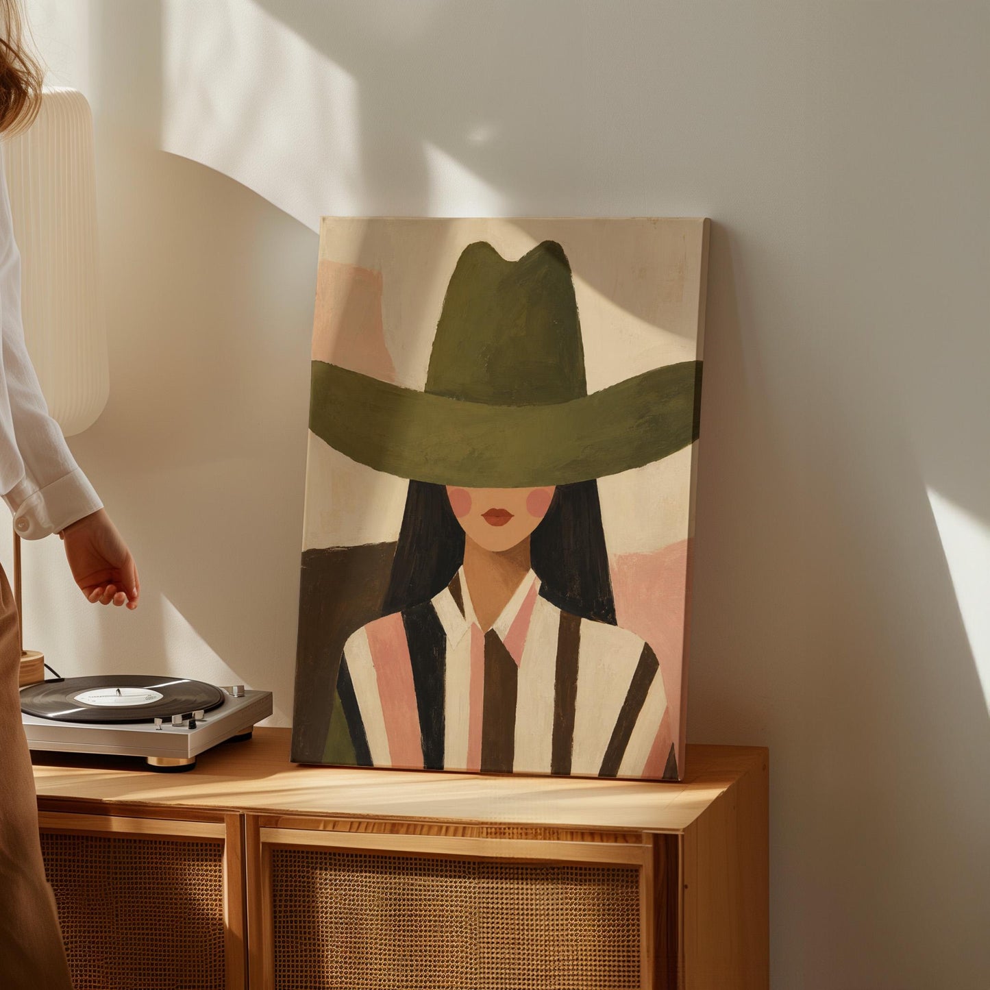 Faceless cowgirl portrait under a broad olive green hat, canvas wall art styled against a soft white wall