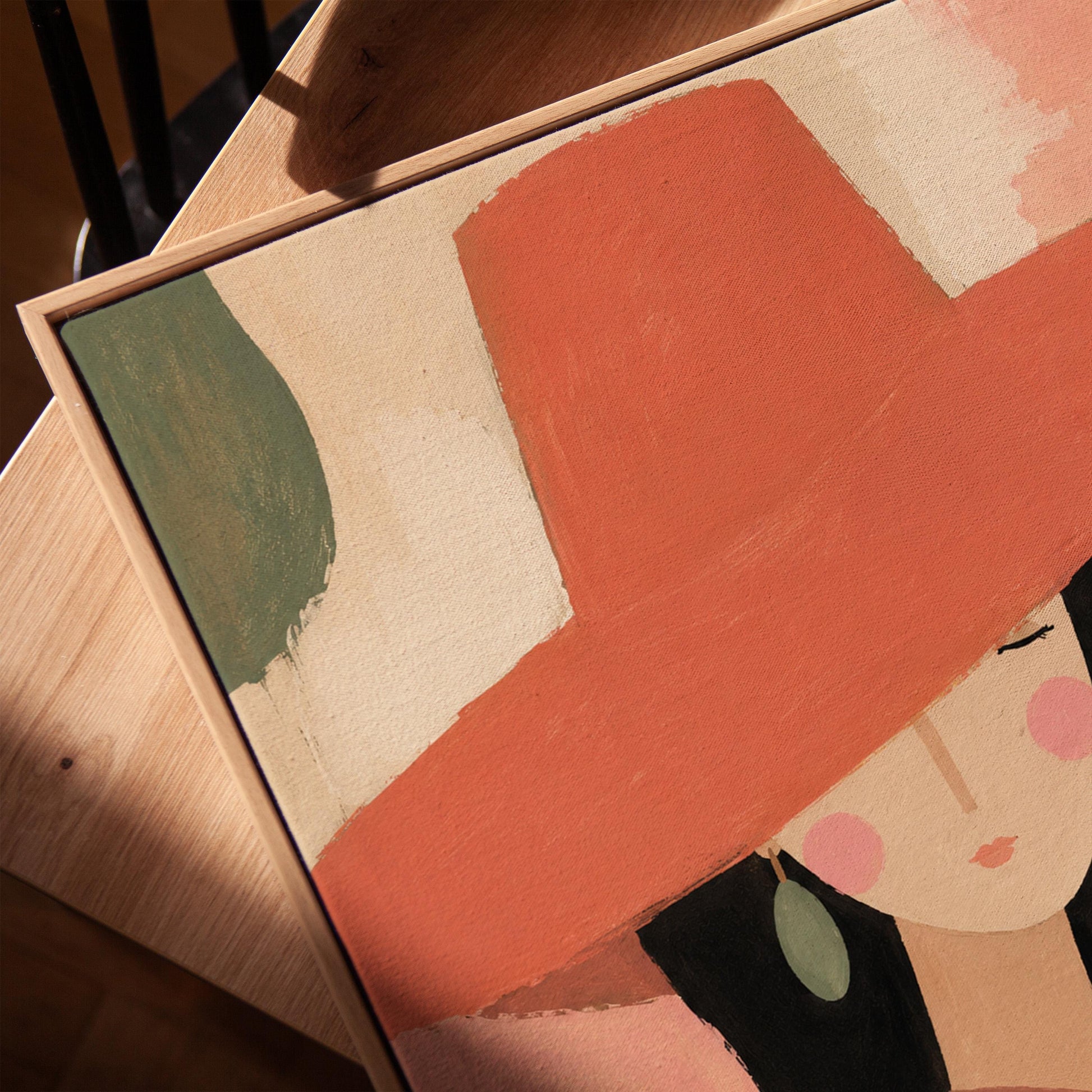 Woman in a wide coral hat with jade earring on blocked color, canvas print in a warm, minimally styled interior