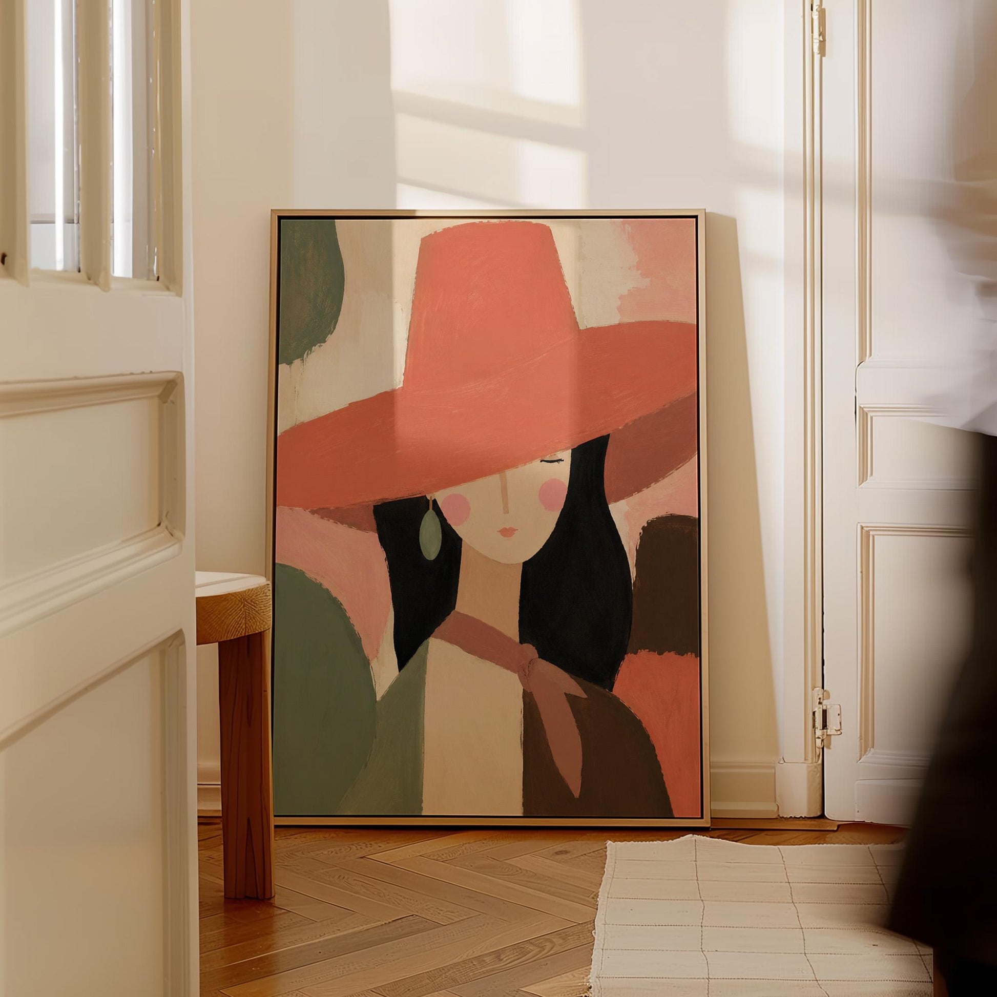 Woman in a wide coral hat with jade earring on blocked color, canvas print styled against a soft white wall