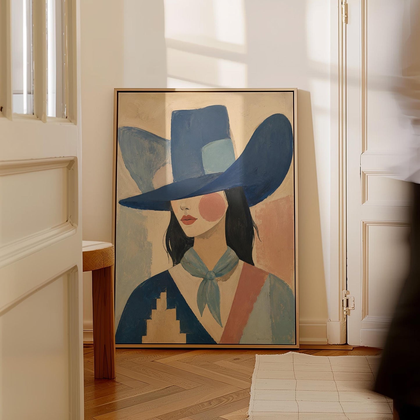 Cowgirl in a deep blue hat and pale scarf on a soft abstract ground, canvas print displayed on a neutral wall in a styled interior