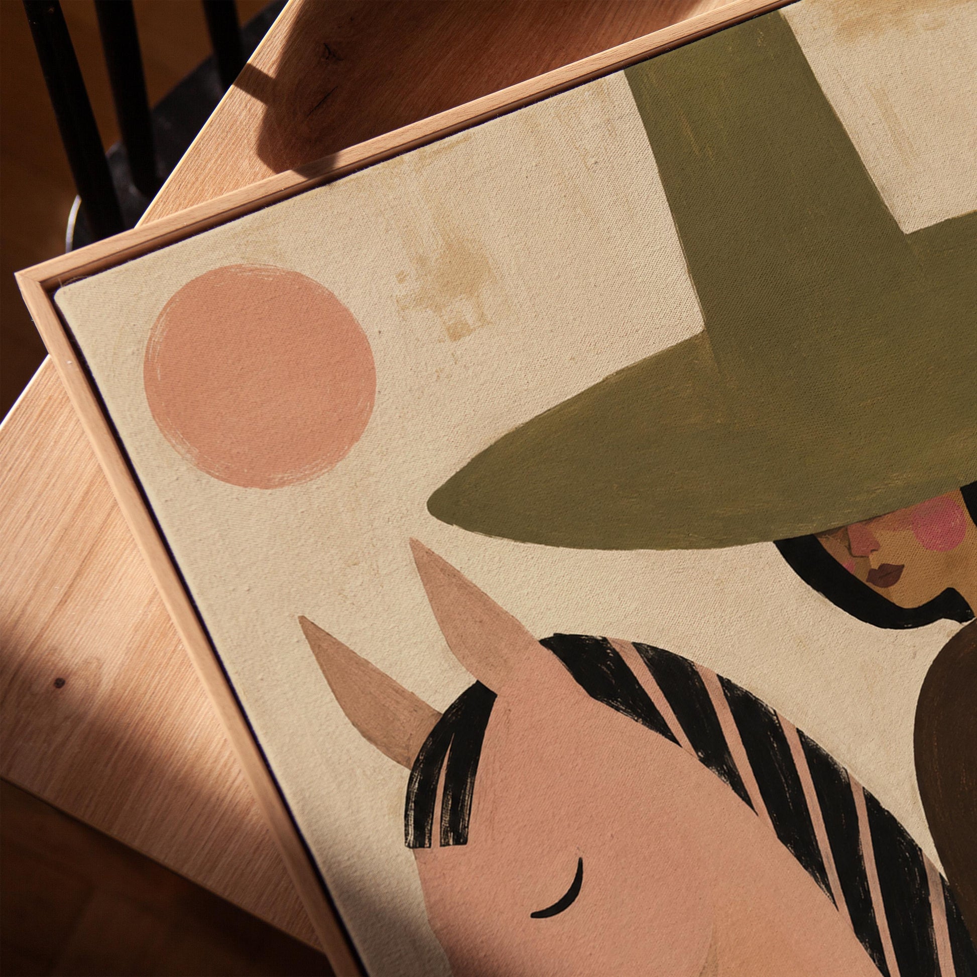 Pink horse beside a cowgirl in an olive hat with leaf motifs, canvas print in a warm, minimally styled interior