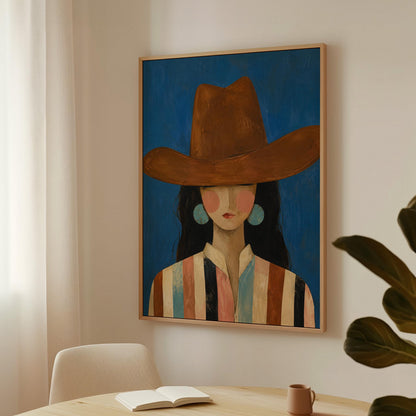 Cowgirl in a brown hat and turquoise earrings on cobalt blue, canvas wall art on a quiet wall in a considered interior