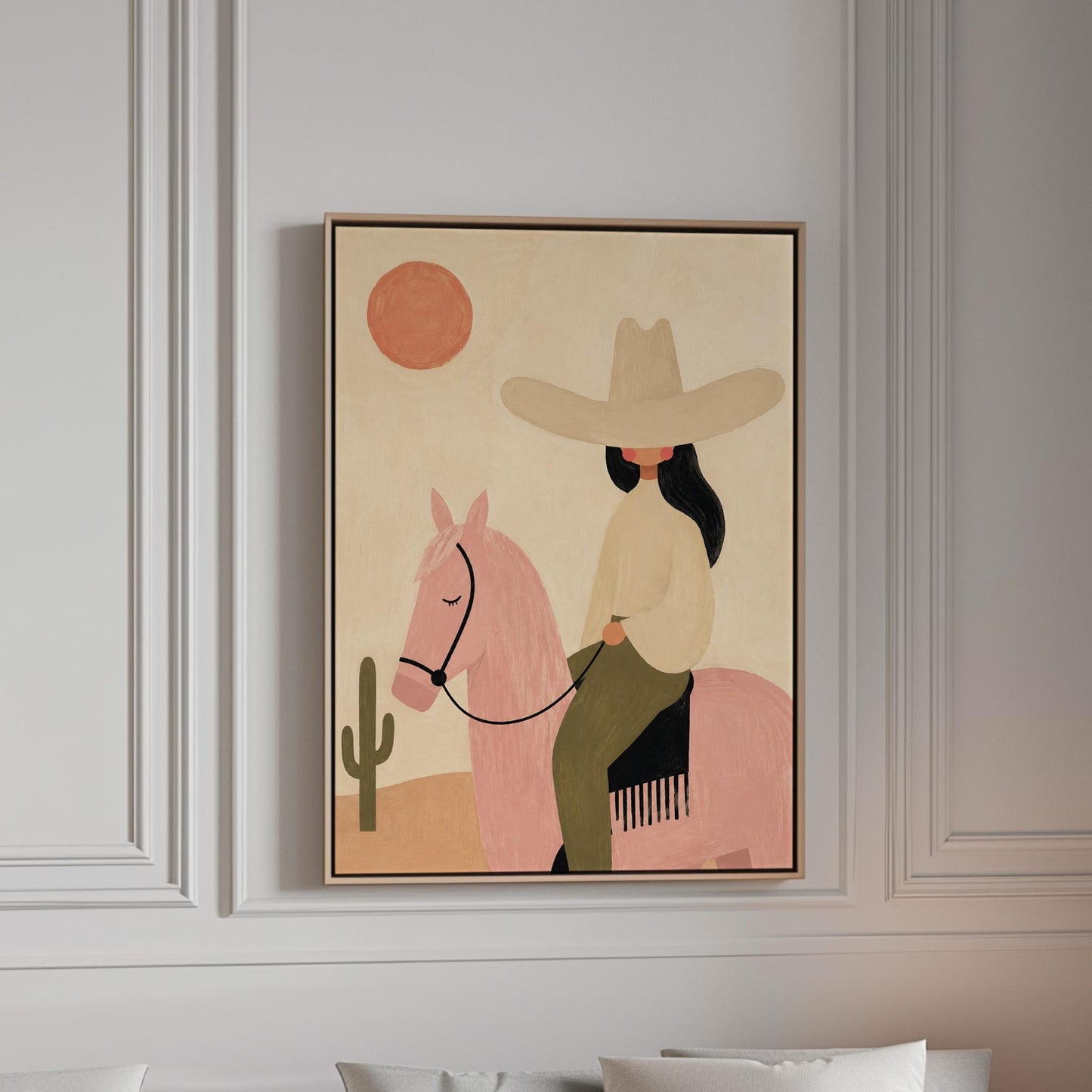 Cowgirl in a pale hat riding a soft pink horse past a desert cactus, canvas print in a bright room with natural daylight