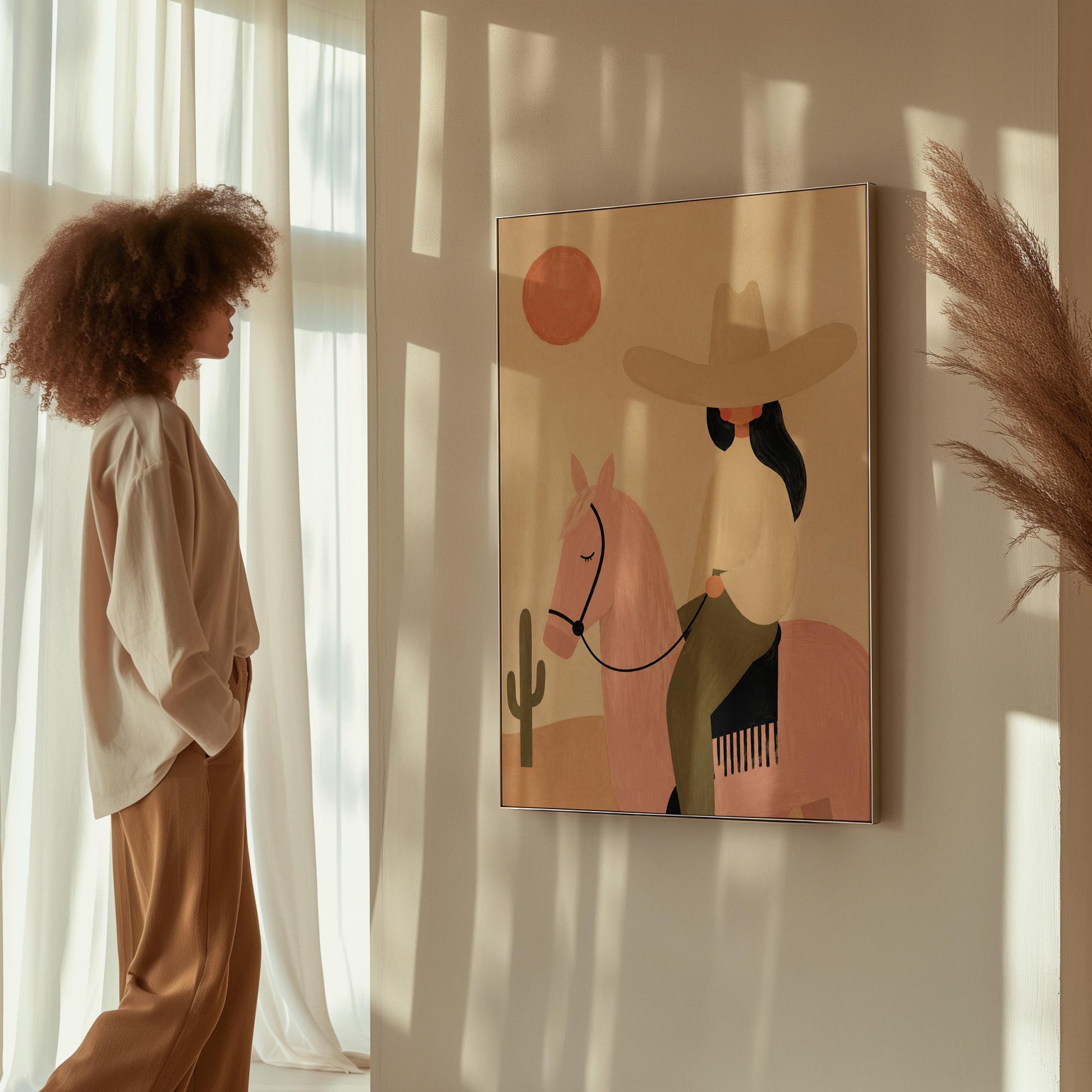 Cowgirl in a pale hat riding a soft pink horse past a desert cactus, canvas print styled against a soft white wall