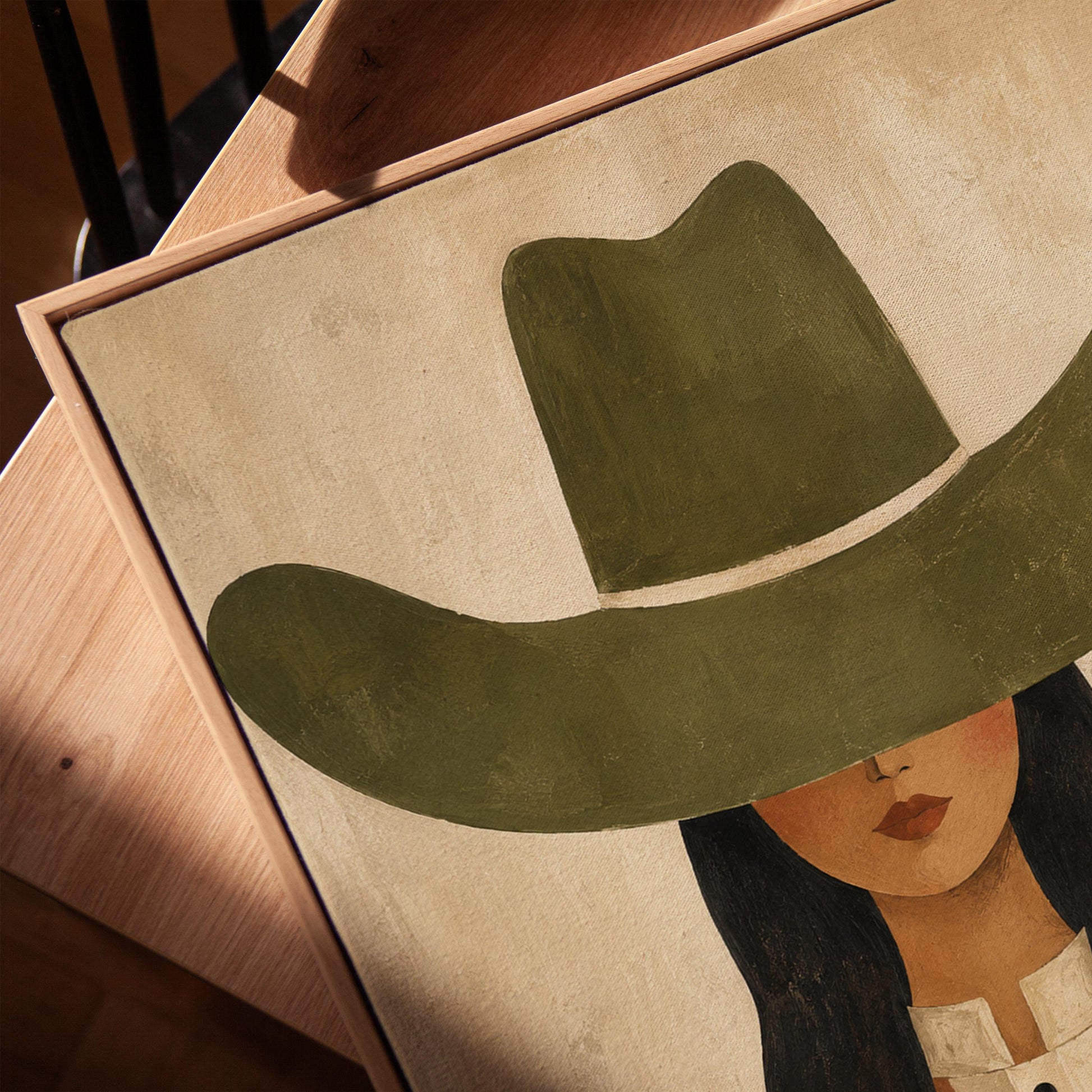 Cowgirl in olive hat and striped western shirt on sandy beige, canvas print in a warm, minimally styled interior