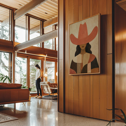 Cowgirl in a broad terracotta hat and patchwork western shirt, canvas print styled against a soft white wall