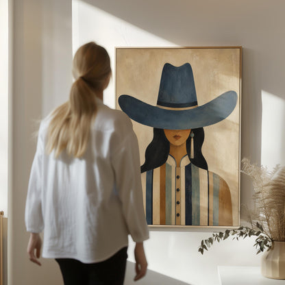 Cowgirl in a slate blue hat and striped shirt on warm sand, canvas print hanging in a calm, modern living space