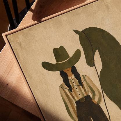 Cowgirl in wide trousers leading a flat olive green horse, canvas print in a warm, minimally styled interior