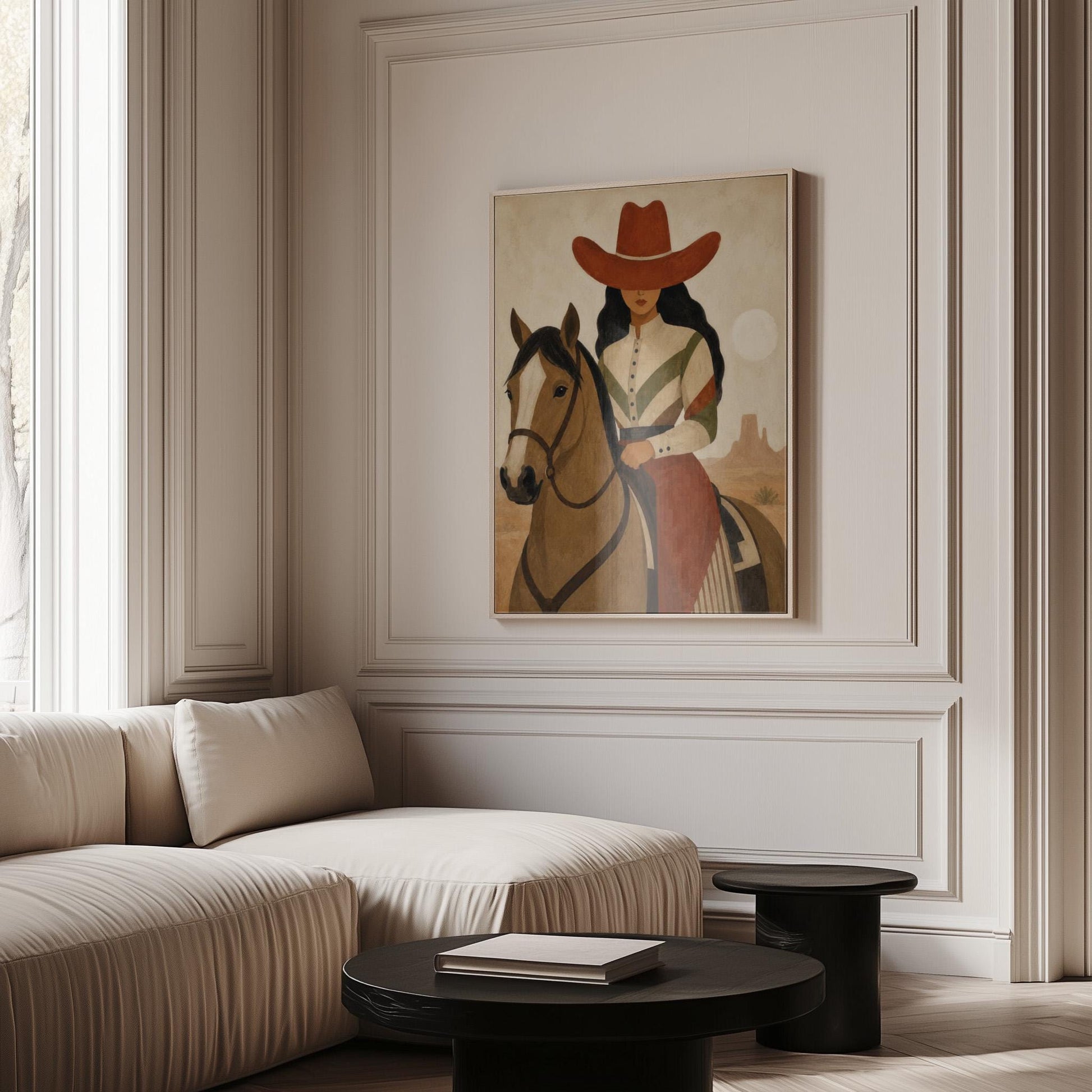 Cowgirl in a red hat riding a bay horse across an ochre desert, canvas print seen in a warm interior with natural light