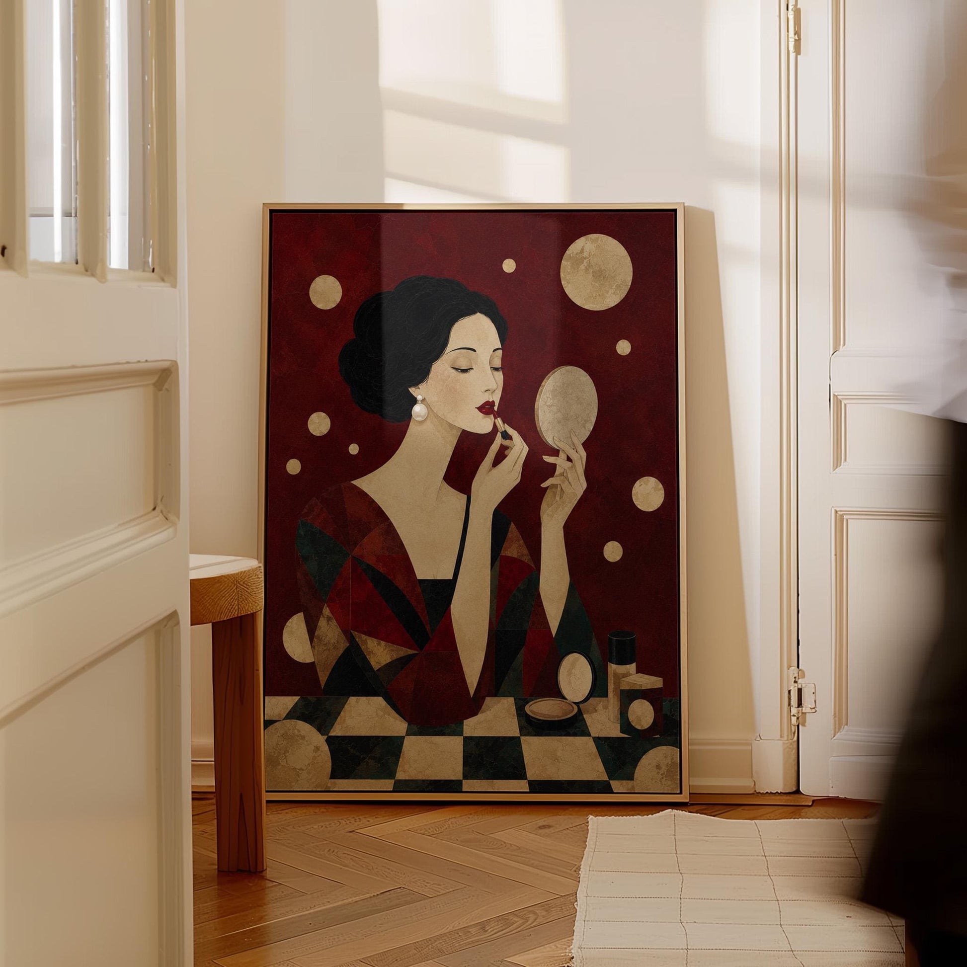 Woman applying red lipstick while holding a hand mirror, canvas print presented in a light, minimal room