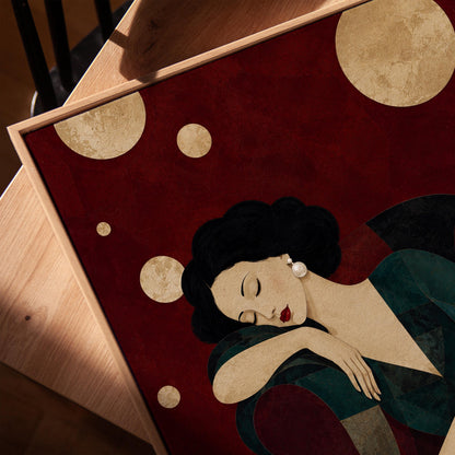 Dark haired woman asleep draped over the back of a deep red armchair, canvas print in a warm, minimally styled interior