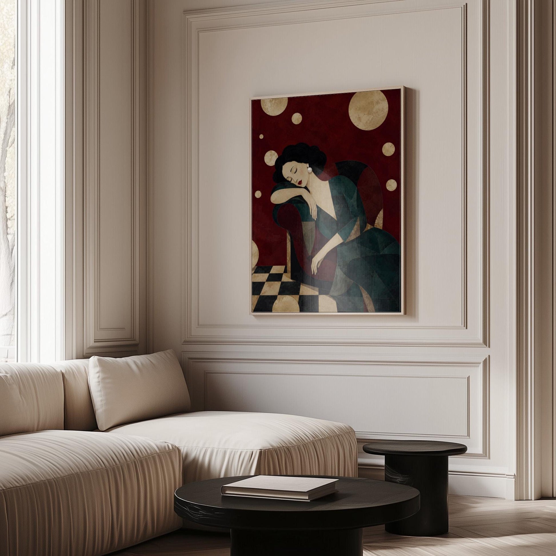 Dark haired woman asleep draped over the back of a deep red armchair, canvas wall art on a quiet wall in a considered interior