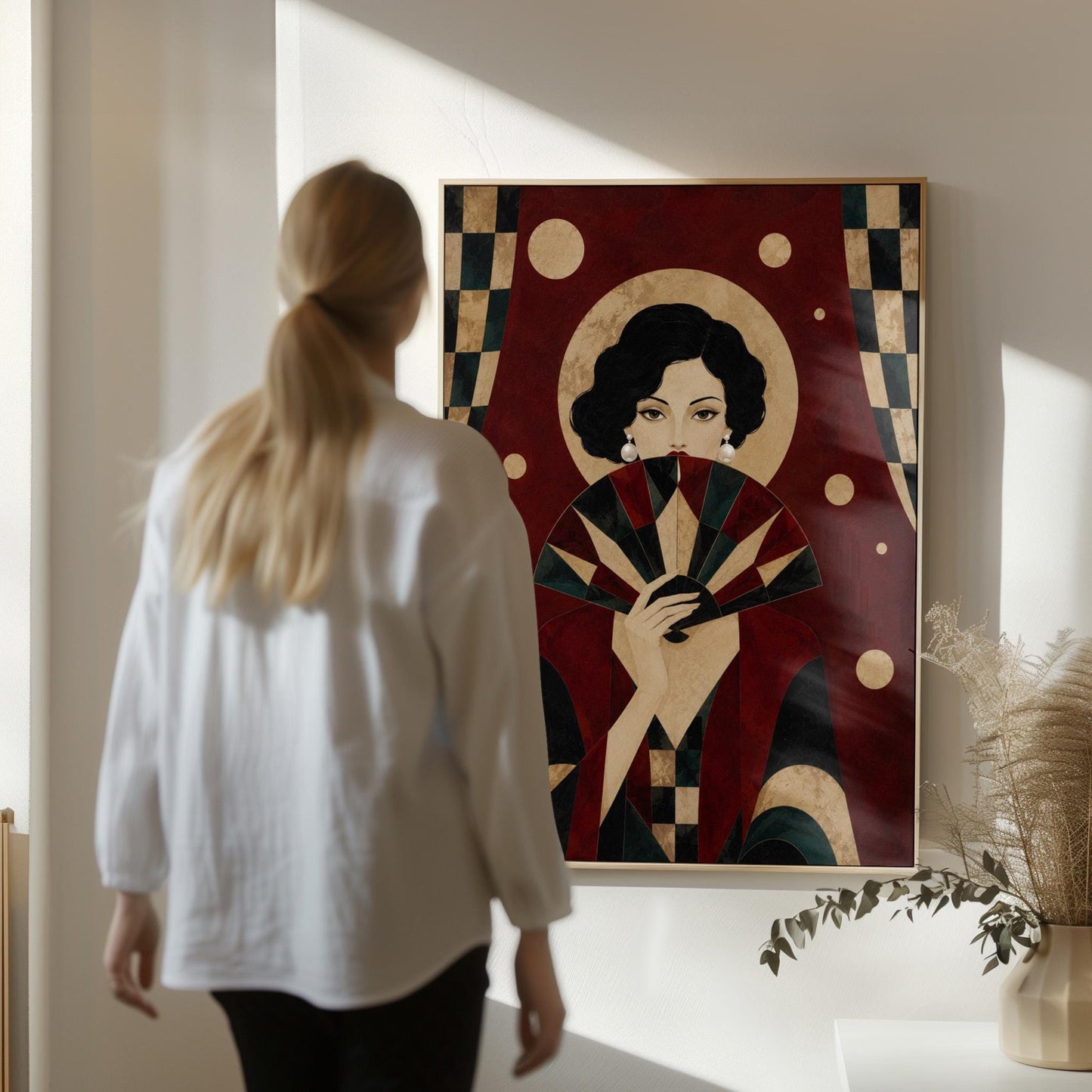 Woman holding a pleated fan to her chin inside a gold halo circle, canvas print hanging in a calm, modern living space