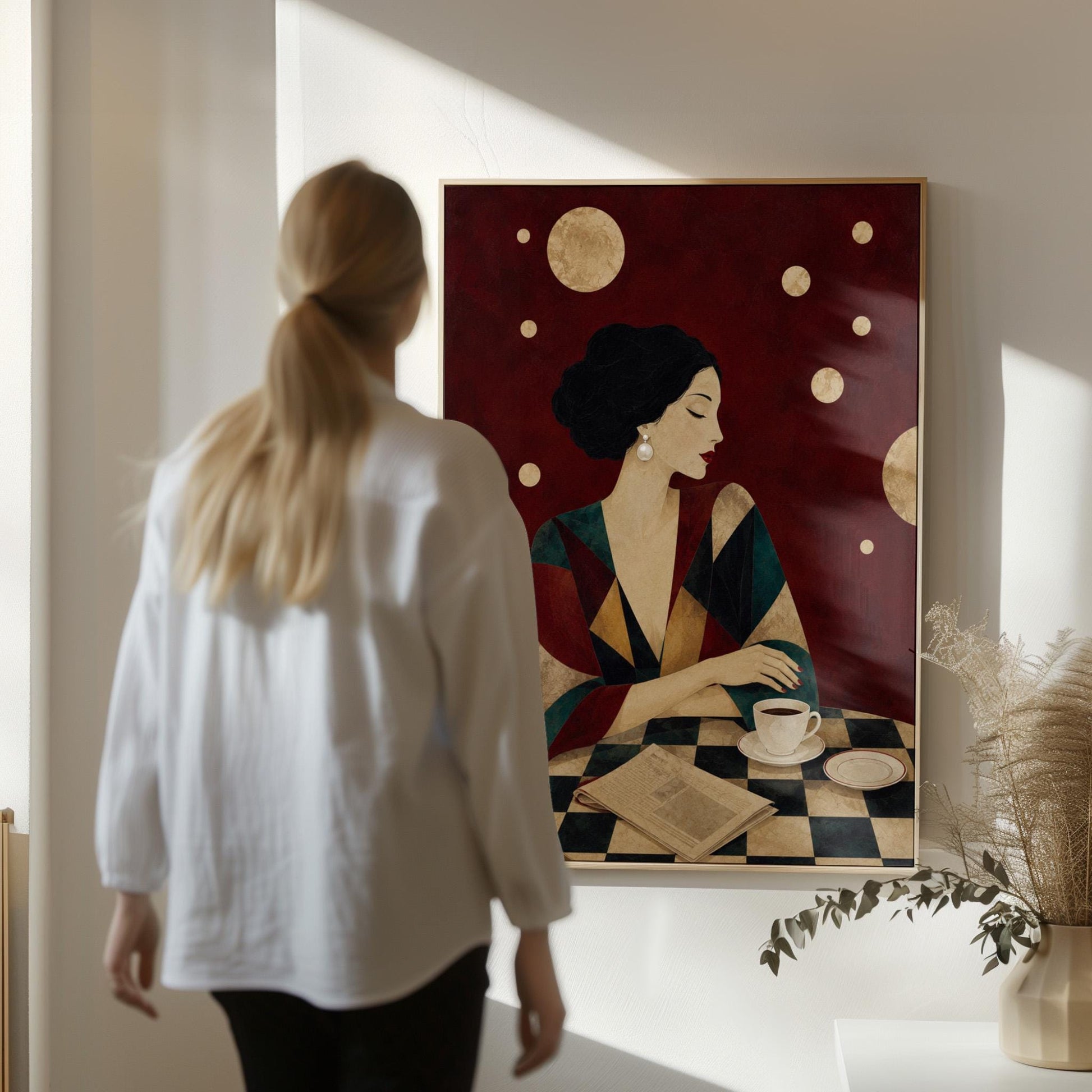 Woman at a cafe table with coffee cup and folded newspaper, canvas wall art styled against a soft white wall