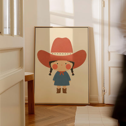 Little cowgirl with braids and rosy cheeks under an oversized red hat, canvas wall art on a quiet wall in a considered interior